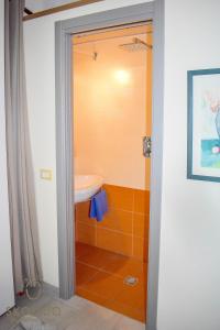 a bathroom with a sink and a shower at Bed, boat and beach in Feriolo direkt am See in Baveno