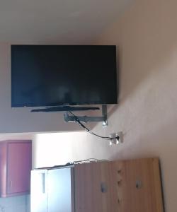 a flat screen tv hanging on a wall at Βίλα Κατερίνα - Villa Katerina in Kokkino Nero
