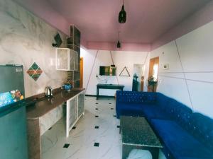 a living room with a blue couch in a room at Sababa Hotel Apartments in Dahab