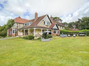 une grande maison avec une grande cour dotée de bancs dans l'établissement Deer Leap House, à Dorchester