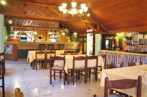 a dining room with tables and chairs in a restaurant at Viking Hotel in Gárdony