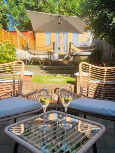 deux verres de vin blanc assis sur une table dans l'établissement Harbour Cottage, à Folkestone