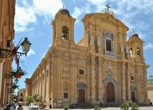 an old church with a cross on top of it at Stella room & apartment in Marsala