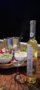 a bottle of wine sitting next to a wine glass at Eco Flat 314 - Hotel Fazenda Pedra do Rodeadoro in Bonito