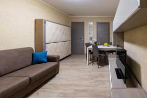 a living room with a couch and a table at Stella room & apartment in Marsala +18 photos
