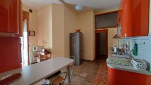 a kitchen with a refrigerator in the corner of a room at Casa Clelia in Teramo