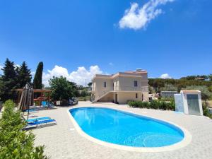 a swimming pool in front of a house at Cristian Rooms in Avola