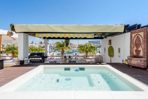a swimming pool on a patio with a table at Marina Real - Sea View by HD PROPERTIES in Vilamoura