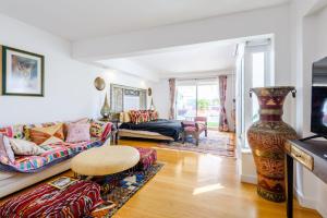 a living room with a couch and a table at Marina Real - Sea View by HD PROPERTIES in Vilamoura