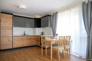a kitchen and dining room with a table and chairs at Modern and Spacious apartments in the City Centre in Sofia