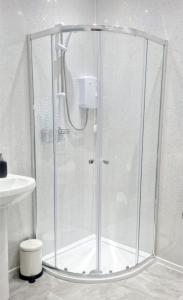 a shower with a glass enclosure in a bathroom at Kilmun Court Villa in Rashfield