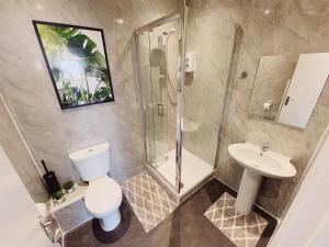 a bathroom with a toilet and a shower and a sink at 2 Bed New Build Apartment - Sleeps 6 - Close to City Centre - Free Parking in Elswick
