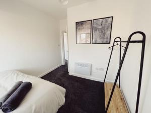 a bedroom with white walls and a bed with black carpet at 2 Bed New Build Apartment - Sleeps 6 - Close to City Centre - Free Parking in Elswick