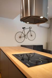 a bike hanging on the wall above a kitchen counter at AthensBlues Glyfada Premium in Athens