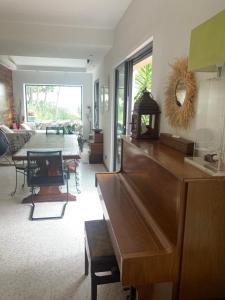 a living room with a table and a dining room at Villa de charme avec piscine et jacuzzi dans cadre exceptionnel proche Marseille in Les-Pennes-Mirabeau