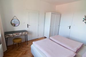 a small bedroom with a bed and a mirror at Apartmán na Kamenci in Teplice nad Metují