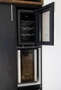 a black cabinet with two microwaves in it at 2ndhomes City Center 2BR Kaisaniemi Park Apartment with Balcony in Helsinki