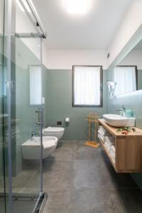 a bathroom with two sinks and a glass shower at Ca' de L'Olif - Holiday Clima Apartments in Dro