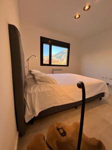 a bedroom with a large bed with a window at Casita de Purmamarca in Purmamarca