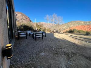 a group of benches sitting on the side of a road at Coquena · Casita con Parrilla y Viñedo in Purmamarca