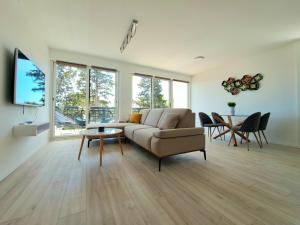a living room with a couch and a table at A2D1 Mali Losinj in Mali Lošinj