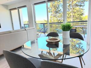 a dining room with a glass table and chairs at A2D1 Mali Losinj in Mali Lošinj