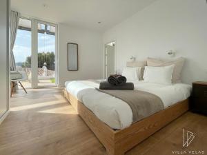 a bedroom with a large bed and a large window at Villa Velas in La Herradura