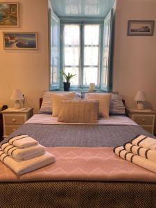 a bedroom with a large bed with towels on it at Patmos Horizon in Patmos