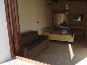 a living room with a couch and a bed at Il Frutteto in Sant' Isidoro +25 photos