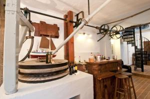 a room with a counter and a table with wine bottles at Molino La Ratonera in Zagra