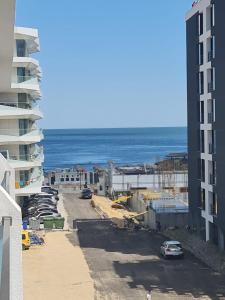 a view of the ocean from the balcony of a building at WAVE 4 Apartments Mamaia Nord in Năvodari