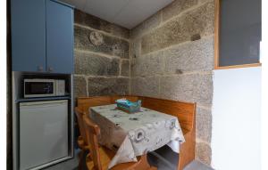 a small kitchen with a table and a refrigerator at Beautiful Apartment In A Arnoia in Arnoia +6 photos