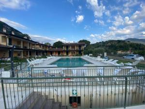 a swimming pool with lounge chairs in a building at Cacao Apartment Iseo lake in Sulzano