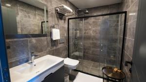 a bathroom with a toilet and a sink and a shower at Ortel Inn in Ordu +46 photos