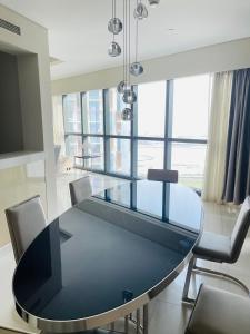 a glass dining room table with chairs and a large window at D3001 Paramount hotel residence 5 star luxury 2bedroom close to Burj Khalifa and Dubai mall in Dubai