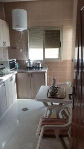 a small kitchen with a table and a counter top at Maison GHITA in Azrou
