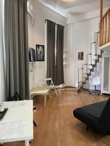 a living room with a staircase and a couch at Studio Piata Amzei NR.1 (8 B) in Bucharest