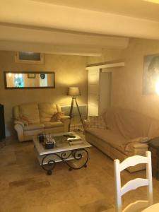 a living room with a couch and a table at Le jardin in Aix-en-Provence