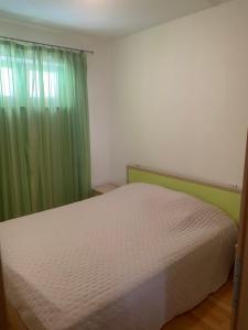 Postel nebo postele na pokoji v ubytování Apartmani IvaMia