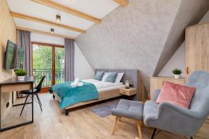 a bedroom with a bed and a desk and a chair at Luxury Salwatoriańska Apartments Mountain View Zakopane by Renters Prestige in Zakopane +128 photos