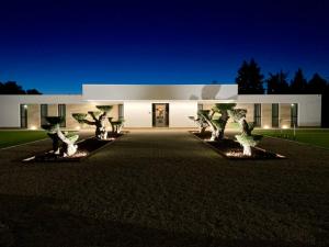 a white building with trees in front of it at VISTA LAGO VILLE in Chiclana de la Frontera