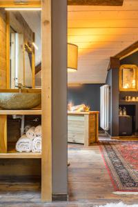 a bathroom with a sink and a counter with towels at John Luxury Suites in Folgaria +81 photos
