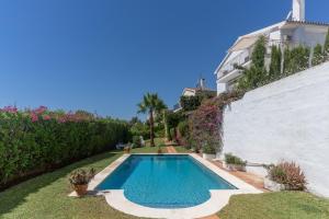 a swimming pool in the yard of a house at Casa Pura Vida in Estepona