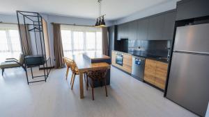 a kitchen with a wooden table and a refrigerator at Ortel Inn in Ordu