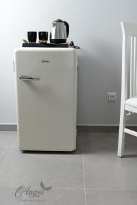 a small white refrigerator sitting in a room at Angel Saranda Palace in Sarandë