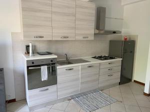 uma cozinha com um fogão, um lavatório e um frigorífico em I Platani 3 em Montecatini Terme