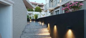 a hallway of a house with stairs and lights at Hotel Doğa Çeşme in Çeşme