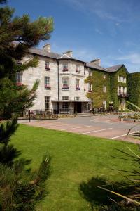 a large building with a parking lot in front of it at The Bulkeley Hotel in Beaumaris