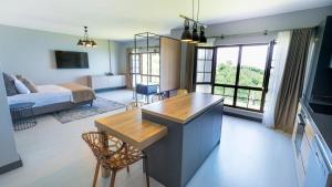 a living room with a kitchen and a bedroom at Ortel Inn in Ordu