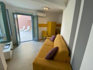 a living room with a couch with pillows on it at Stone on the lake in Baveno